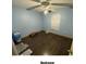 A bedroom with dark wood flooring and a ceiling fan at 4605 N 39Th St # 1/2, Tampa, FL 33610