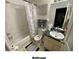 A bathroom with a tub, toilet, and vanity with a dark countertop at 4605 N 39Th St # 1/2, Tampa, FL 33610