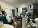 A cluttered garage with various storage items and shelving at 4605 N 39Th St # 1/2, Tampa, FL 33610