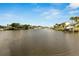 Calm canal with docked boats and lush greenery at 636 Yardarm Dr # 636, Apollo Beach, FL 33572