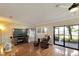 Spacious living room with hardwood floors and access to a patio at 636 Yardarm Dr # 636, Apollo Beach, FL 33572