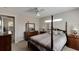 Bright bedroom with a post bed, ceiling fan, and adjacent hallway at 636 Yardarm Dr # 636, Apollo Beach, FL 33572