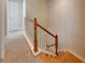 Upstairs hallway with carpeted flooring and wooden staircase at 636 Yardarm Dr # 636, Apollo Beach, FL 33572