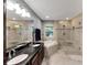Spa-like bathroom featuring a double vanity, soaking tub, and a large walk-in shower at 636 Yardarm Dr # 636, Apollo Beach, FL 33572