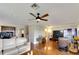 Living room with hardwood floors, off-white sectional sofa and ceiling fan at 636 Yardarm Dr # 636, Apollo Beach, FL 33572