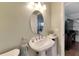 Powder room with oval mirror and pedestal sink at 636 Yardarm Dr # 636, Apollo Beach, FL 33572