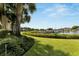 Landscaped backyard with a view of boats docked at a marina at 636 Yardarm Dr # 636, Apollo Beach, FL 33572