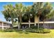 Exterior view of condo building showcasing lush landscaping and palm trees at 636 Yardarm Dr # 636, Apollo Beach, FL 33572