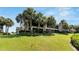 Exterior view of the condo building with palm trees and green lawn at 636 Yardarm Dr # 636, Apollo Beach, FL 33572