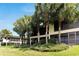 Exterior view of condo showing lush landscaping and palm trees at 636 Yardarm Dr # 636, Apollo Beach, FL 33572