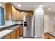 Kitchen with stainless steel refrigerator and granite countertops at 636 Yardarm Dr # 636, Apollo Beach, FL 33572