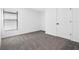 Simple bedroom with grey carpet, window blinds, and white door at 29508 Fedora Cir, Brooksville, FL 34602