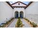 Two-story townhome with a courtyard entry and teal doors at 17231 Holly Well Ave, Wimauma, FL 33598