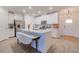 Spacious kitchen with island, stainless steel appliances, and white cabinetry at 17231 Holly Well Ave, Wimauma, FL 33598