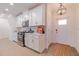Modern kitchen with white cabinets and stainless steel appliances at 17231 Holly Well Ave, Wimauma, FL 33598