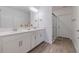 Modern bathroom with double vanity and walk-in shower at 17231 Holly Well Ave, Wimauma, FL 33598