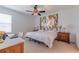 Spacious bedroom with large art piece and ample natural light at 17231 Holly Well Ave, Wimauma, FL 33598