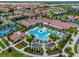 Resort-style pool, tennis courts, and clubhouse in community at 17231 Holly Well Ave, Wimauma, FL 33598