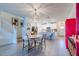 Elegant dining area showcasing a round table and chairs, with a view of the kitchen and staircase at 17231 Holly Well Ave, Wimauma, FL 33598