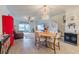 Open concept dining room with a round table and chairs, adjacent to the living room and kitchen at 17231 Holly Well Ave, Wimauma, FL 33598