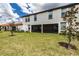 Two-story home with screened porch and landscaped backyard at 17231 Holly Well Ave, Wimauma, FL 33598