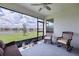 Enjoy the view from this screened porch with wicker furniture and ceiling fan at 17231 Holly Well Ave, Wimauma, FL 33598