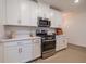 Modern kitchen with stainless steel appliances and white cabinets at 17231 Holly Well Ave, Wimauma, FL 33598