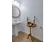 Stylish powder room with pedestal sink and decorative accents at 17231 Holly Well Ave, Wimauma, FL 33598