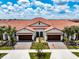 Two-story townhome with a Mediterranean style and two-car garage at 17231 Holly Well Ave, Wimauma, FL 33598