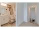 Guest bathroom with toilet, sink, and access to stairs at 17231 Holly Well Ave, Wimauma, FL 33598