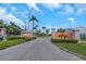 Community entrance with signage and lush landscaping at 8699 Bardmoor Blvd # 304, Seminole, FL 33777