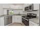 Modern kitchen with stainless steel appliances and white cabinets at 8699 Bardmoor Blvd # 304, Seminole, FL 33777