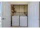 Bright laundry room with washer and dryer, and built-in shelving at 8699 Bardmoor Blvd # 304, Seminole, FL 33777