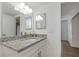 Bathroom with granite countertop, white cabinets, and a large mirror at 8699 Bardmoor Blvd # 304, Seminole, FL 33777