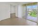 Living room with sliding door to balcony and pool view at 8699 Bardmoor Blvd # 304, Seminole, FL 33777