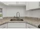 Kitchen sink with granite countertop and white cabinets at 8699 Bardmoor Blvd # 304, Seminole, FL 33777