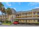 Two-story condo building with palm trees and parking at 8699 Bardmoor Blvd # 304, Seminole, FL 33777