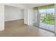 Living area with tile floors and access to balcony at 8699 Bardmoor Blvd # 304, Seminole, FL 33777