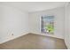 Bedroom with tile floors and large window with blinds at 8699 Bardmoor Blvd # 304, Seminole, FL 33777