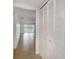 Hallway with tile floor and white louvered doors at 8699 Bardmoor Blvd # 304, Seminole, FL 33777