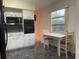 Kitchen features white cabinets, black appliances, and a breakfast nook at 2310 Denmark St # 50, Clearwater, FL 33763