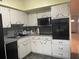 Galley kitchen with updated appliances and ample cabinet space at 2310 Denmark St # 50, Clearwater, FL 33763