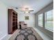 Home office with built-in bookcase and ceiling fan at 13503 Willow Bluestar Loop, Riverview, FL 33579