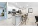 Kitchen island with seating, granite countertops, and white shaker cabinets at 13503 Willow Bluestar Loop, Riverview, FL 33579