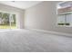 Spacious living room with sliding glass doors leading to the backyard at 32884 Estate Garden Dr, Wesley Chapel, FL 33545