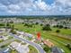 Aerial view showcasing the home's location near a golf course and the surrounding neighborhood at 609 Fox Hills Dr, Sun City Center, FL 33573