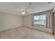 Carpeted room with fan, window, and curtains providing natural light at 609 Fox Hills Dr, Sun City Center, FL 33573