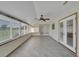 Sunroom with tile floor, windows offering a view, and ceiling fan at 609 Fox Hills Dr, Sun City Center, FL 33573