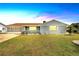 Charming single-story home with a brick exterior, well-manicured lawn, and attached garage at 609 Fox Hills Dr, Sun City Center, FL 33573