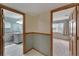 Hallway with access to a bathroom and bedroom with bright light at 609 Fox Hills Dr, Sun City Center, FL 33573